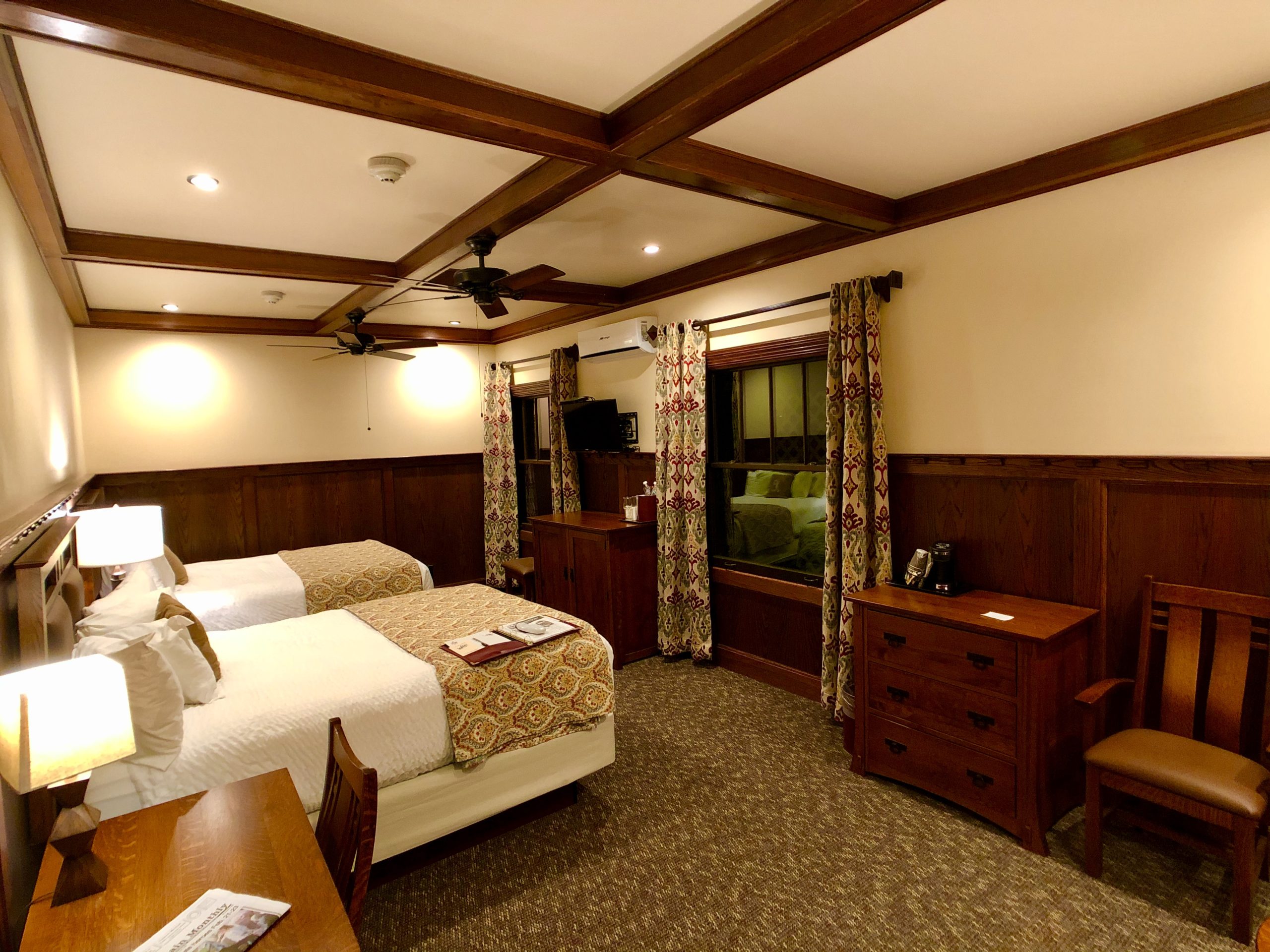 A view of a Double Queen Platinum Room facing the windows and dressers.